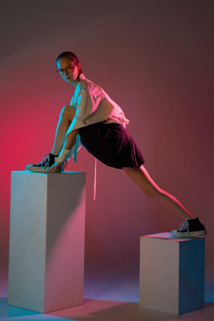 a woman wearing a mask and standing on a podium