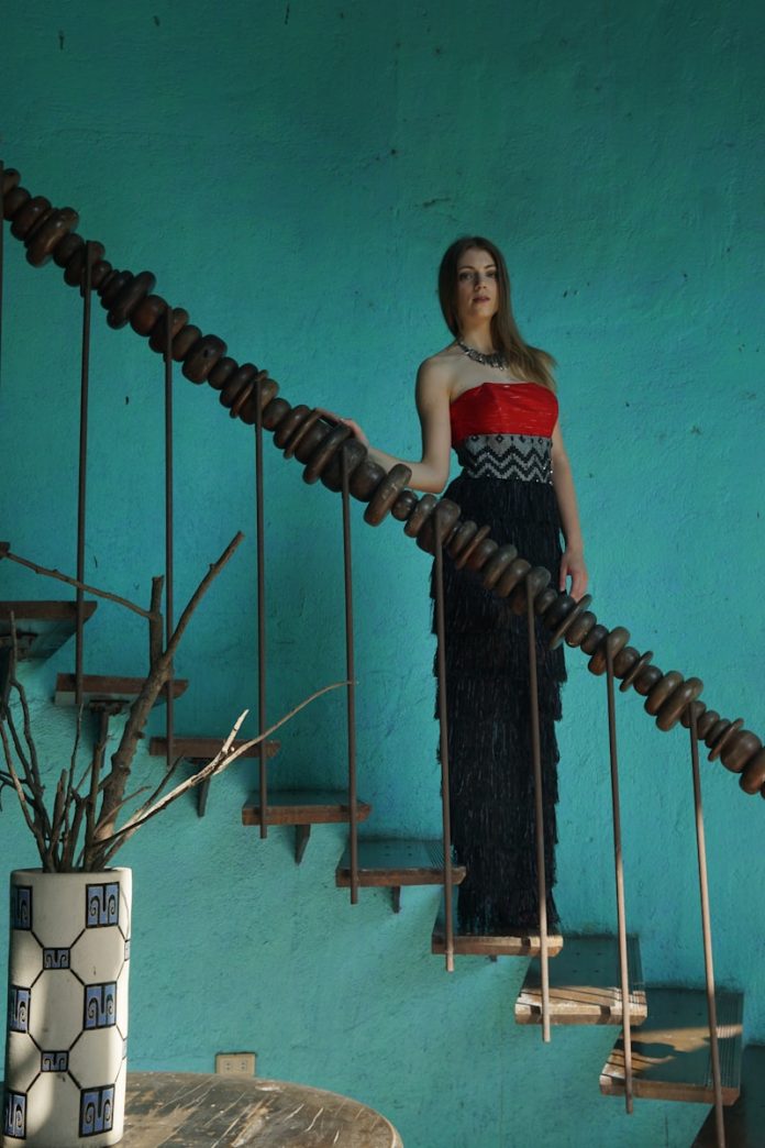 A woman is standing on a stair case