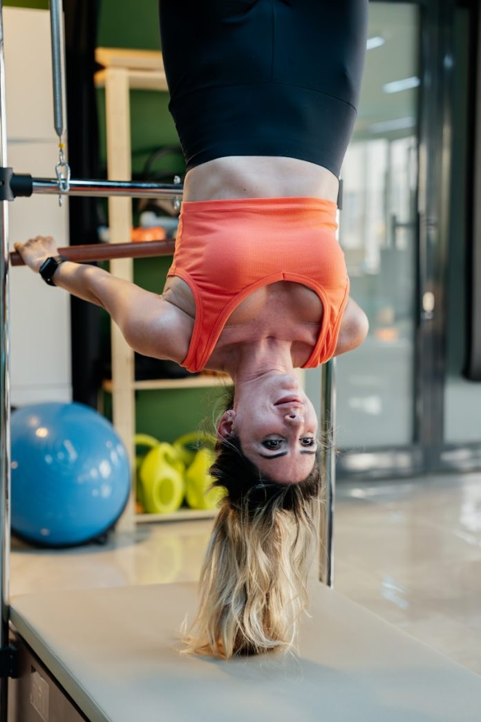 Woman inverting while doing pilates.